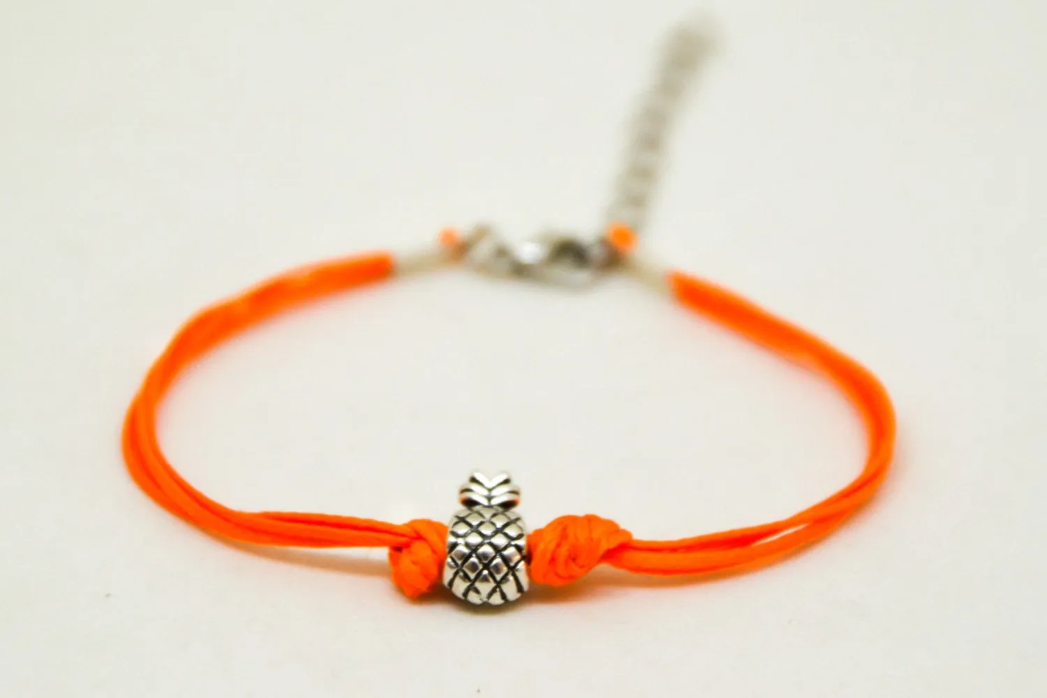 Silver pineapple charm bead bracelet with orange cord, tropical jewelry